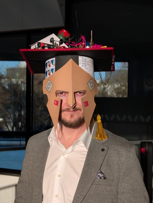 The newly awarded doctor Tarik Sahin wearing the doctoral hat lovingly crafted by his colleagues.