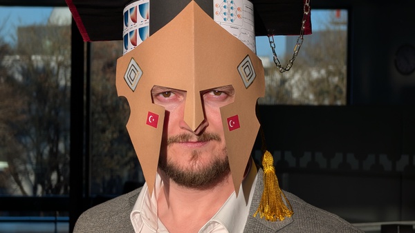 The newly awarded doctor Tarik Sahin wearing the doctoral hat lovingly crafted by his colleagues.