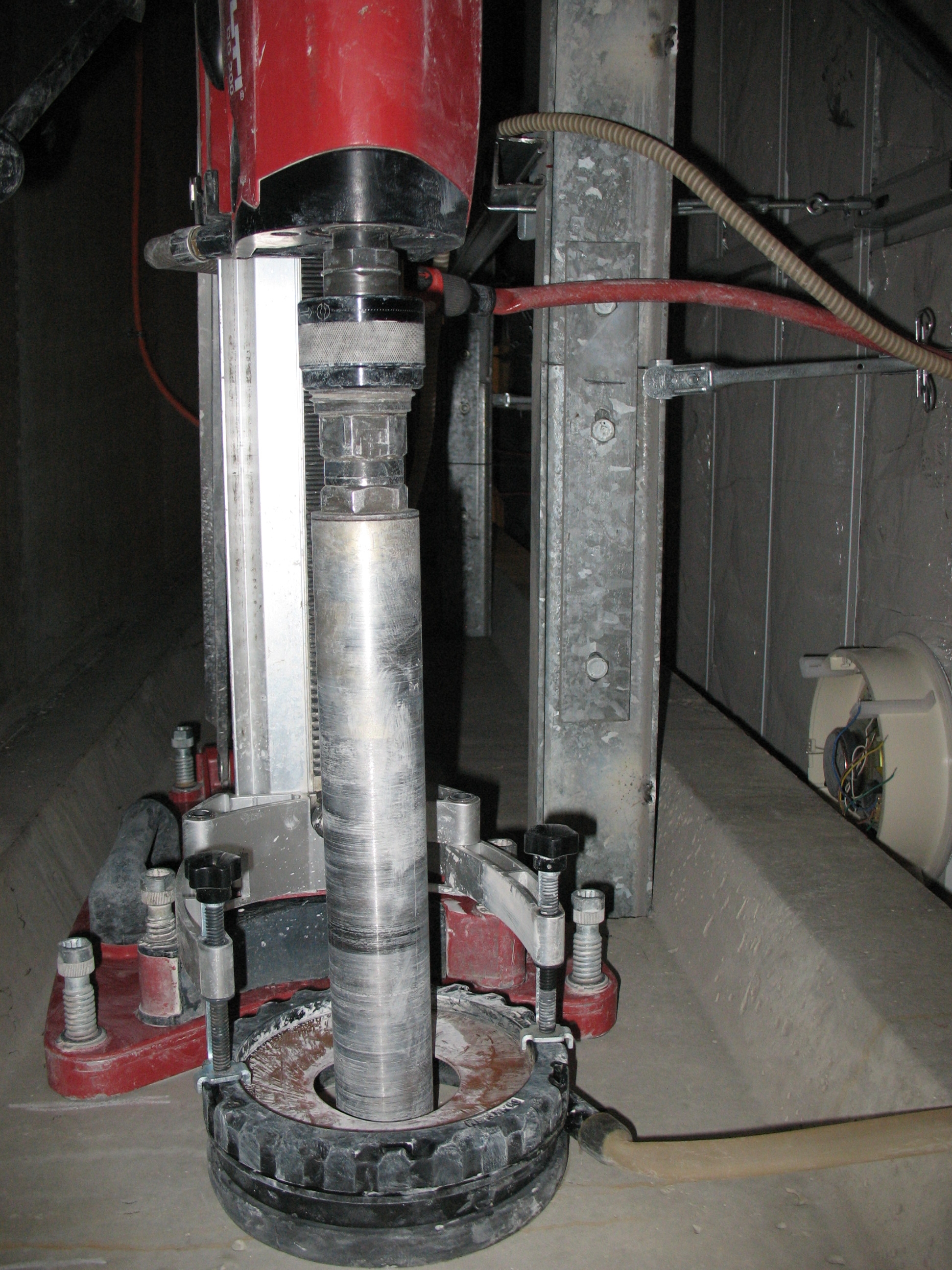 core drill in action on a balcony using a guide